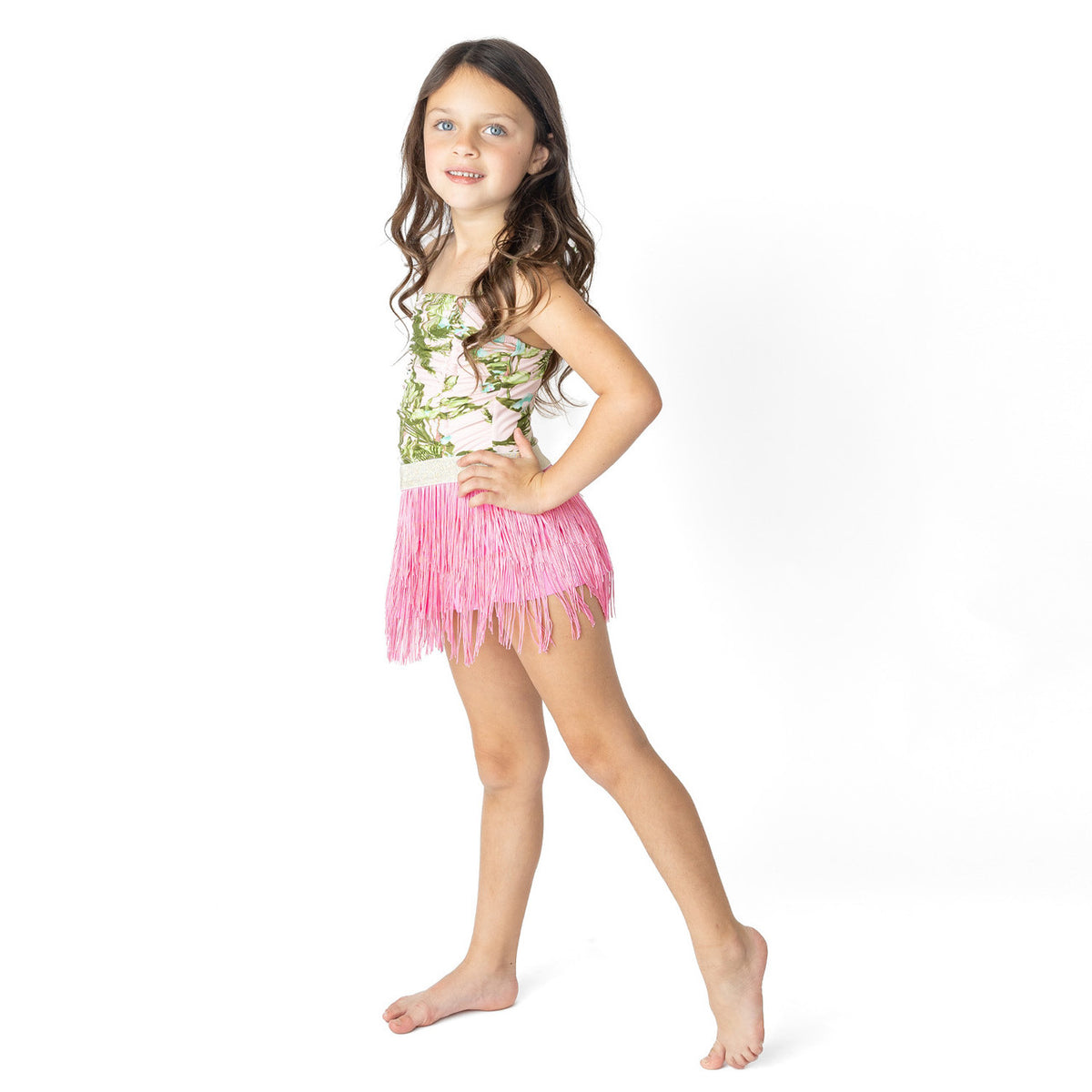 Side view of girls tropical print one piece with bright pink fringe skirt.