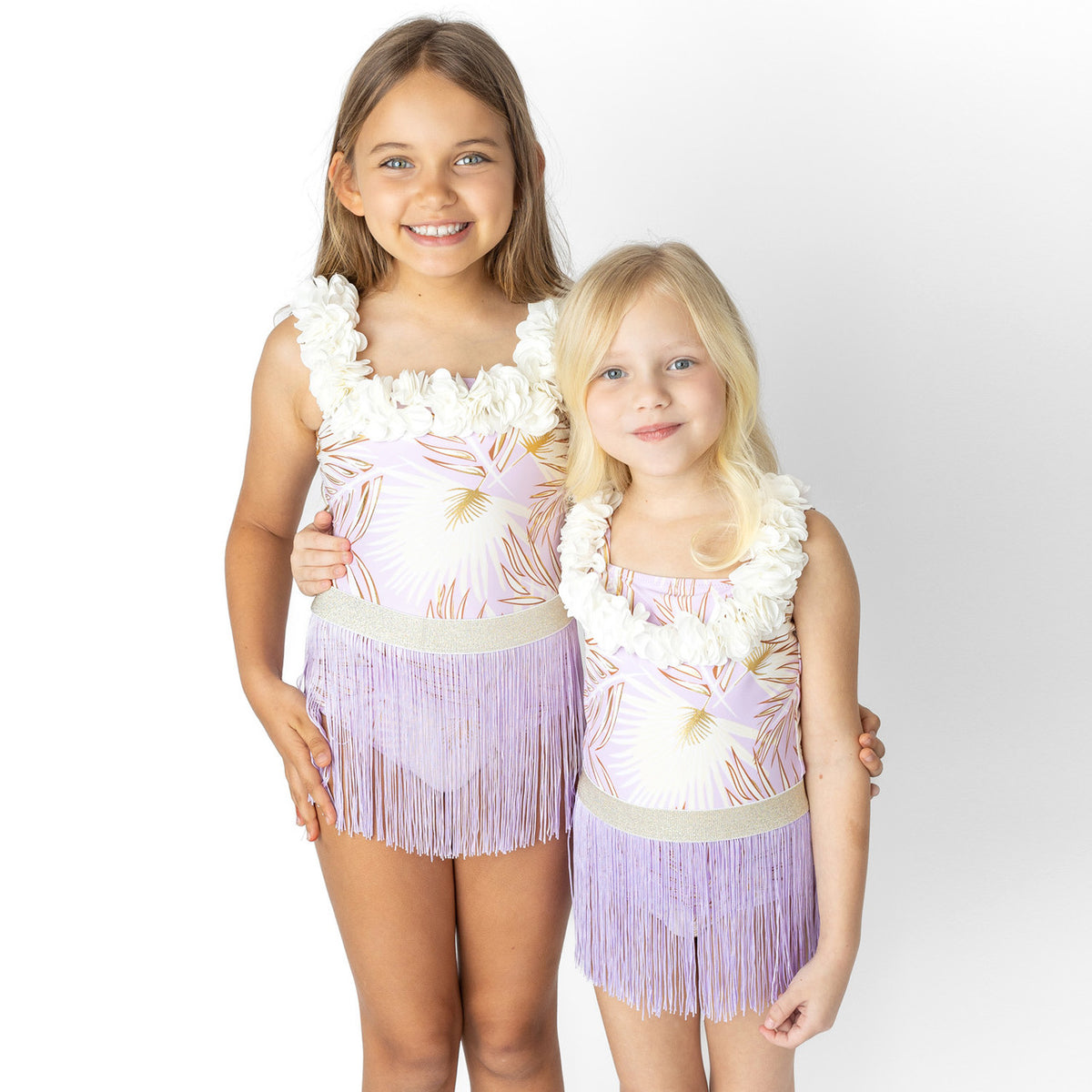 Girls wearing Purple Metallic Hula Girl one piece swimsuit with fringe skirt.