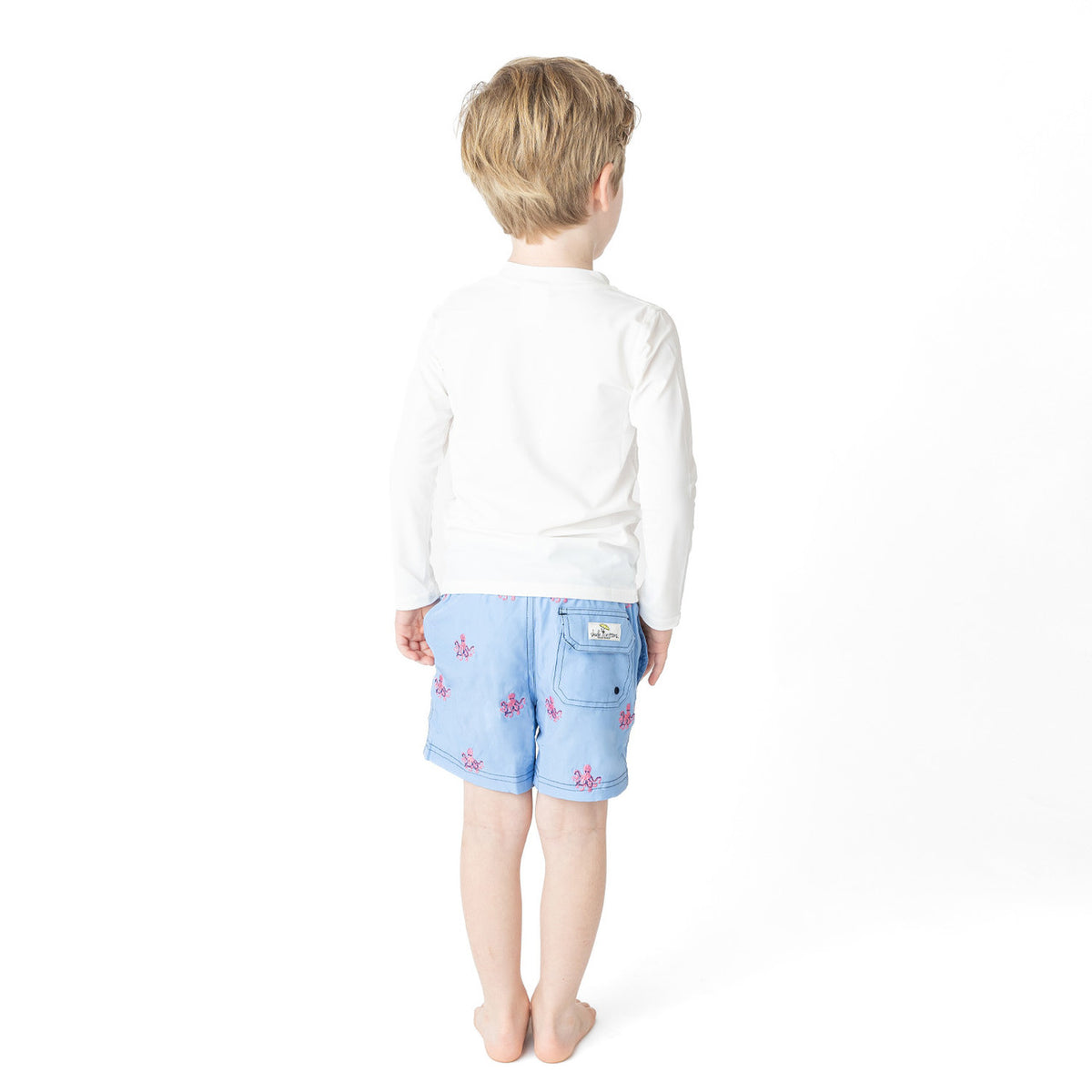 Back view of boys Octopus Icon swim trunks on model showing fit and length.