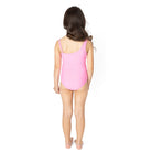 Back view of pink one shoulder girls one piece swimsuit on model.