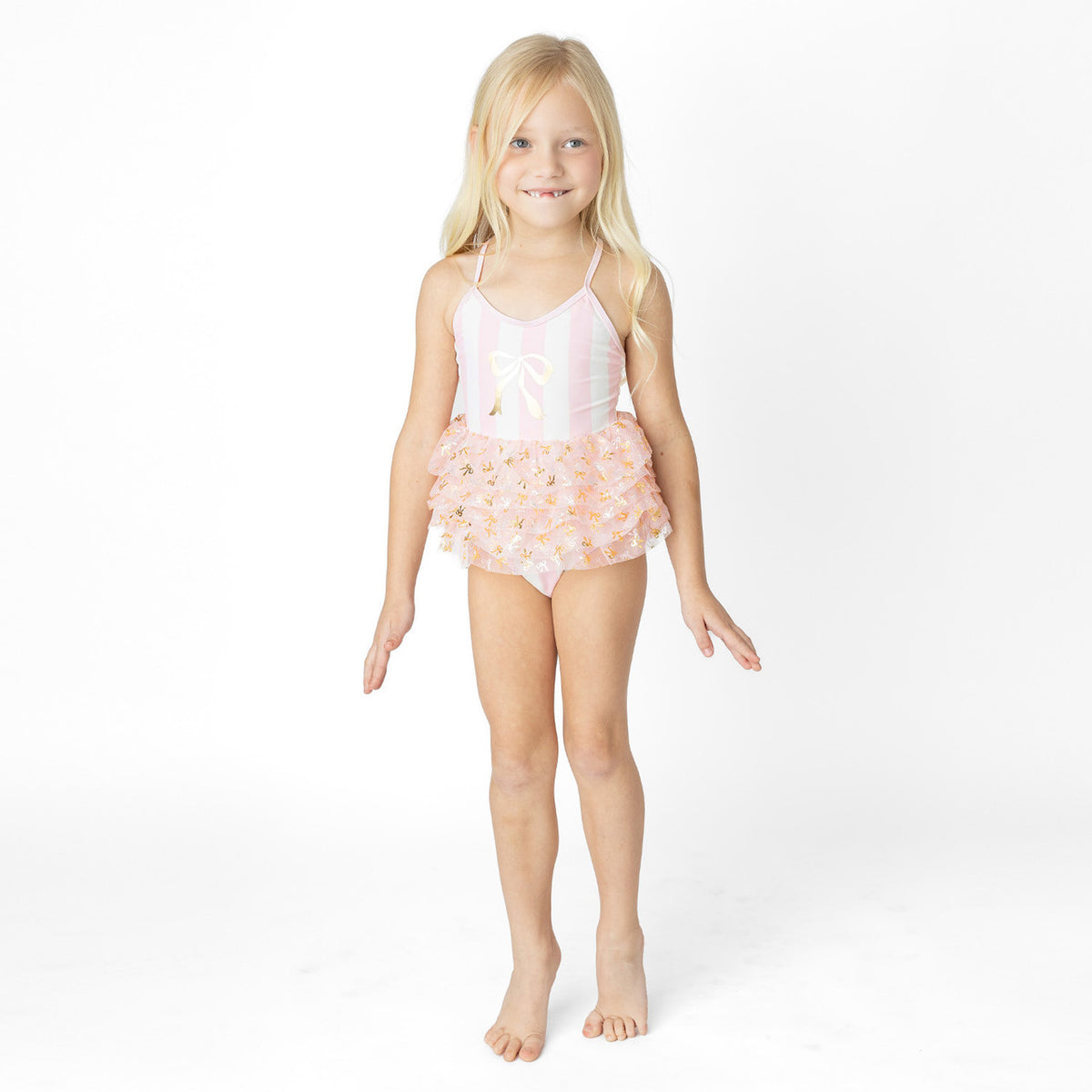 Girls blush stripe skirted one piece swimsuit on model showing fit.