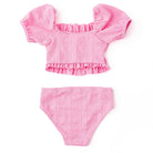 Girls pink eyelet smocked bikini set with puff sleeve top and matching bottoms, trendy kids swimwear.