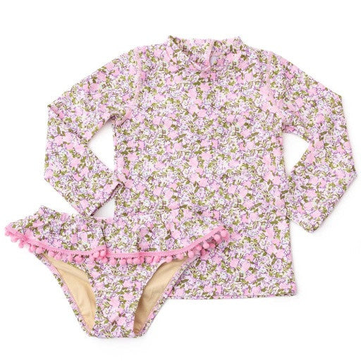 The Shade Critters Blushing Blooms Girls Rashguard Swim Set displayed flat, showing the floral-print rashguard top with coordinating pink pom-pomtrimmed bottoms.